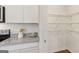 Kitchen with granite counters and large walk-in pantry with metal shelving at 147 Oakchase Park Ln, Hampton, GA 30228