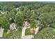 An aerial view showcasing the home's location nestled among lush greenery and neighboring houses at 203 First Leaf, Peachtree City, GA 30269