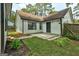 Backyard featuring a green lawn and the exterior of a white one-story home with black trim and a dark door at 203 First Leaf, Peachtree City, GA 30269