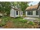 Backyard featuring lush greenery, studio with a yellow door, and a patio creates an inviting outdoor space at 203 First Leaf, Peachtree City, GA 30269