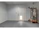 Unfinished basement with water heater and access to the outdoors at 203 First Leaf, Peachtree City, GA 30269