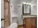 Well-lit bathroom with vanity, granite countertop, framed mirror, and decorative sconces creating a stylish retreat at 203 First Leaf, Peachtree City, GA 30269