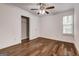 Bright bedroom with hardwood floors, closet, and a ceiling fan creating a cozy and comfortable space at 203 First Leaf, Peachtree City, GA 30269