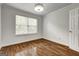 Bright bedroom with hardwood floors, large window, and neutral walls creating a relaxing and inviting space at 203 First Leaf, Peachtree City, GA 30269