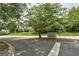 An inviting neighborhood entrance to Center Green with lush landscaping and street view at 203 First Leaf, Peachtree City, GA 30269
