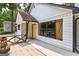 View of the front entrance featuring a charming yellow door, wooden accents, and well-kept siding at 203 First Leaf, Peachtree City, GA 30269