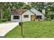 Charming white bungalow with a yellow door and a neatly manicured lawn at 203 First Leaf, Peachtree City, GA 30269