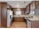 Spacious kitchen features stainless steel appliances, ample storage, and dark cabinetry at 203 First Leaf, Peachtree City, GA 30269