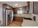 Well-appointed kitchen with stainless steel appliances, granite countertops and dark cabinets at 203 First Leaf, Peachtree City, GA 30269