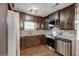 Modern kitchen with granite countertops, stainless steel appliances, and dark wood cabinetry at 203 First Leaf, Peachtree City, GA 30269