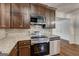 Updated kitchen features granite countertops, stainless steel appliances, and wood cabinets at 203 First Leaf, Peachtree City, GA 30269