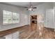 Inviting living room with hardwood floors, bright windows, and an open view to the kitchen at 203 First Leaf, Peachtree City, GA 30269