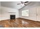 Bright living room features a fireplace, large window, and stylish hardwood floors at 203 First Leaf, Peachtree City, GA 30269