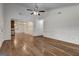 Open-concept living room with hardwood floors connecting to the kitchen and dining area at 203 First Leaf, Peachtree City, GA 30269