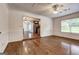 Open-concept living room with hardwood floors, wainscoting and abundant natural light at 203 First Leaf, Peachtree City, GA 30269