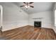 Cozy living room with hardwood floors, a fireplace, and bright windows at 203 First Leaf, Peachtree City, GA 30269