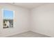 Bright bedroom with plush carpeting and a large window providing natural light at 636 Whitman Ln # 2035, Stockbridge, GA 30281