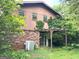 View of backyard with small pergola and brick foundation at 8832 Twin Oaks Dr, Jonesboro, GA 30236