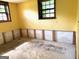 Unfinished basement offering a blank canvas with natural light from two windows at 8832 Twin Oaks Dr, Jonesboro, GA 30236
