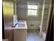 The bathroom features a double sink vanity, decorative mirror and tub shower combo at 8832 Twin Oaks Dr, Jonesboro, GA 30236