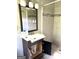 Bathroom features modern vanity, decorative mirror, and tiled shower with a pebble floor at 8832 Twin Oaks Dr, Jonesboro, GA 30236