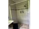 This bathroom boasts a tiled shower with a built-in niche and a pebble floor at 8832 Twin Oaks Dr, Jonesboro, GA 30236