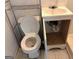 Bathroom with a toilet, sink, vanity, and chrome shelving offering functionality at 8832 Twin Oaks Dr, Jonesboro, GA 30236