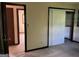 Cozy bedroom featuring neutral carpeting, a sliding-door closet, and adjoining room at 8832 Twin Oaks Dr, Jonesboro, GA 30236
