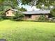 Charming home featuring a brick facade and lush green lawn at 8832 Twin Oaks Dr, Jonesboro, GA 30236