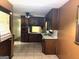 This kitchen has brown cabinets and tile flooring at 8832 Twin Oaks Dr, Jonesboro, GA 30236
