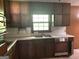 Traditional kitchen features a window and brown cabinets at 8832 Twin Oaks Dr, Jonesboro, GA 30236