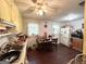 Eat-in kitchen with tile countertops, hardwood floor, and yellow cabinets at 3683 Miller St, Lithia Springs, GA 30122