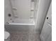 Bathroom featuring a white bathtub with a white surround and decorative tile flooring at 2873 Shoals Hill Ct, Dacula, GA 30019