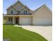 Charming two-story home with a well-manicured lawn and a spacious three-car garage at 2873 Shoals Hill Ct, Dacula, GA 30019