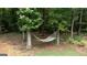 Backyard with hammock strung between mature trees offering a relaxing outdoor space at 10 Stagg Trce, Social Circle, GA 30025