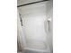 Bathtub with tile surround and shower, with decorative curtain and bath accessories at 10 Stagg Trce, Social Circle, GA 30025