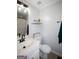 Bathroom with a single sink vanity, decorated shelf, and bath with shower at 10 Stagg Trce, Social Circle, GA 30025