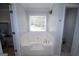 Relaxing soaking tub nestled beneath a window, offering a private retreat at 10 Stagg Trce, Social Circle, GA 30025