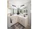 Bright bathroom featuring dual sinks, white cabinetry, and modern lighting at 10 Stagg Trce, Social Circle, GA 30025