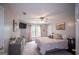 Bright bedroom with a ceiling fan and dresser, offering a comfortable and inviting retreat with carpeted floors at 10 Stagg Trce, Social Circle, GA 30025
