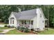 Side view of a white home with a charming front porch and a second-story deck with an outside stairway at 10 Stagg Trce, Social Circle, GA 30025