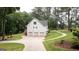 Charming home featuring a three-car garage and a beautifully landscaped yard with a winding walkway at 10 Stagg Trce, Social Circle, GA 30025