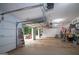 The garage has an open door, an automatic garage door opener, and space for tools and equipment at 10 Stagg Trce, Social Circle, GA 30025