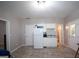 This kitchen features a refrigerator, and cabinets with an adjacent door to a bathroom and an exterior door at 10 Stagg Trce, Social Circle, GA 30025