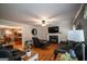Cozy living room with a fireplace and plush seating, adjacent to an open-concept kitchen and dining area at 10 Stagg Trce, Social Circle, GA 30025