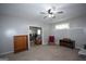 The living room has carpet and a ceiling fan with furniture, offering a comfortable space for relaxation and entertainment at 10 Stagg Trce, Social Circle, GA 30025