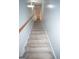 Carpeted stairs ascending with a wood handrail and white walls at 10 Stagg Trce, Social Circle, GA 30025