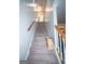 Carpeted stairway with wooden handrail ascends to the upper level of the home at 10 Stagg Trce, Social Circle, GA 30025