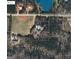 Aerial view of the property with mature trees, a pond, and surrounded by open land at 1000 Turner Church Rd, Mcdonough, GA 30252