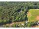 Aerial view of the property with mature trees and a lush green lawn at 1000 Turner Church Rd, Mcdonough, GA 30252